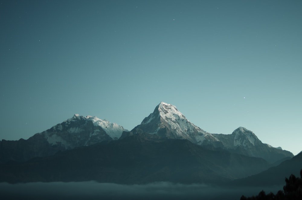 snow capped mountain range on a still day