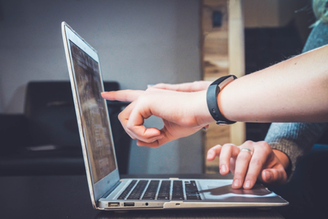 fingers pointing at a laptop