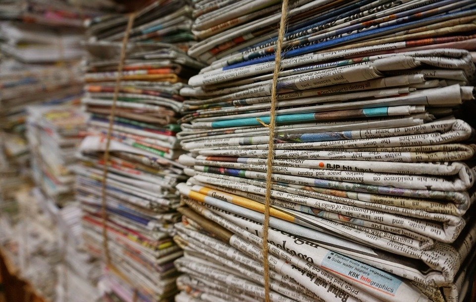 Stacks of newspapers with adverts