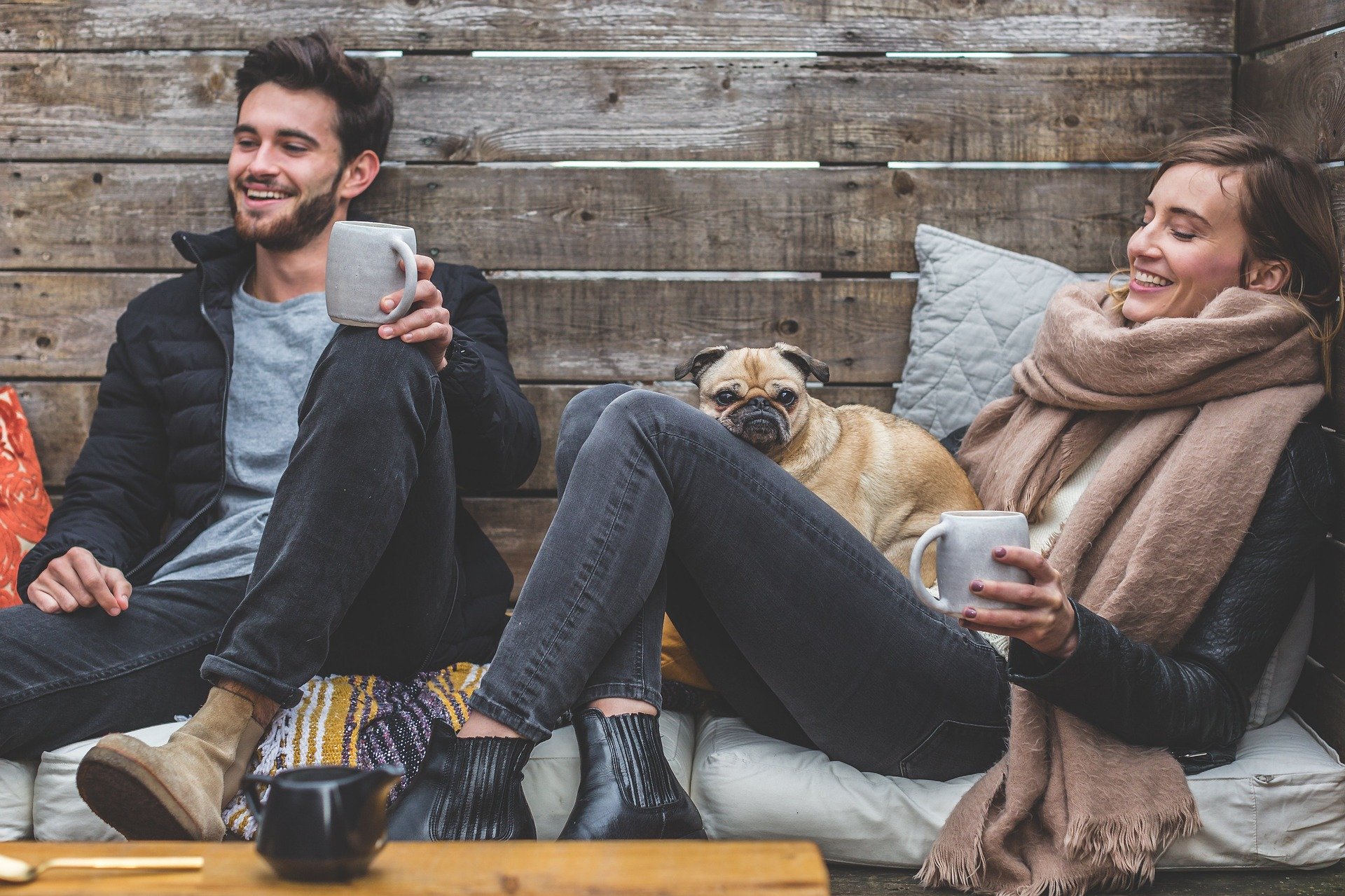 Two people relaxing with a dog and enjoying a conversation